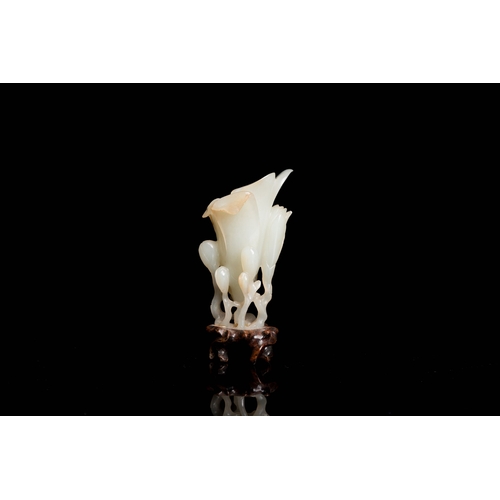 485 - A Chinese white jade 'magnolia' carving, QingDescription:H.: 8 cm (incl. glued stand) Provenance:- T... 