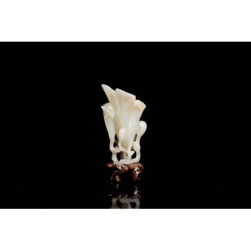 485 - A Chinese white jade 'magnolia' carving, QingDescription:H.: 8 cm (incl. glued stand) Provenance:- T... 