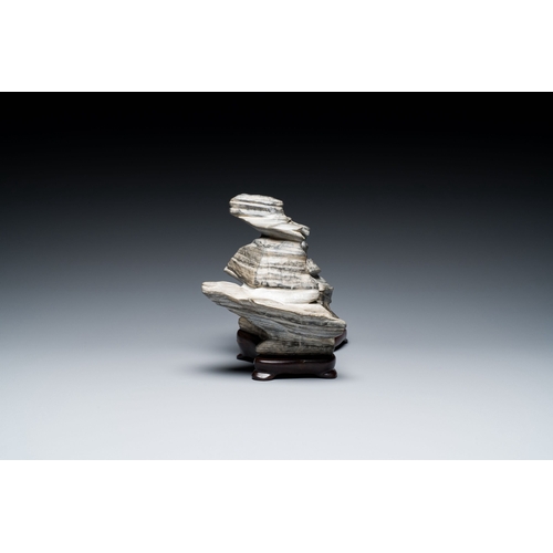 517 - A Chinese grey lingbi stone scholar's rock on wooden stand, 19/20th C.Description:Dim.: 24,5 x 14,5 ... 