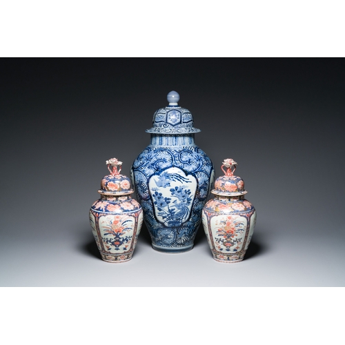 532 - A pair of Japanese Imari vases with flower-topped covers and a large blue and white Arita vase, Edo,... 