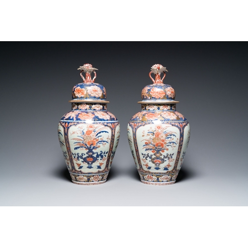 532 - A pair of Japanese Imari vases with flower-topped covers and a large blue and white Arita vase, Edo,... 