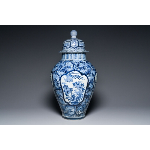 532 - A pair of Japanese Imari vases with flower-topped covers and a large blue and white Arita vase, Edo,... 