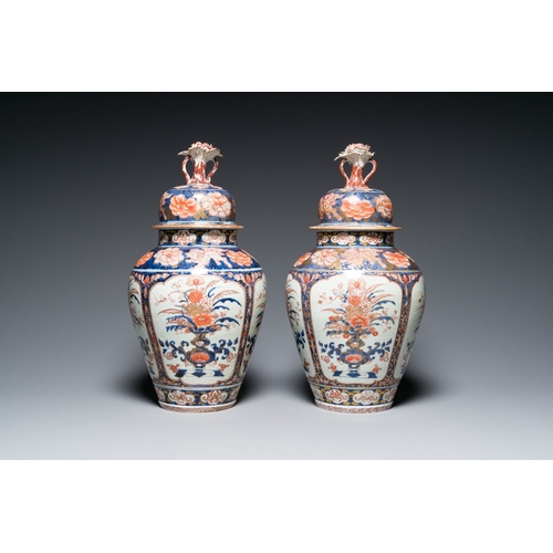 532 - A pair of Japanese Imari vases with flower-topped covers and a large blue and white Arita vase, Edo,... 