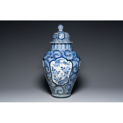 532 - A pair of Japanese Imari vases with flower-topped covers and a large blue and white Arita vase, Edo,... 