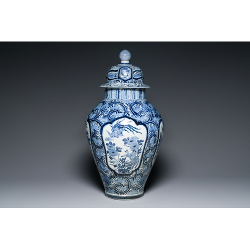 532 - A pair of Japanese Imari vases with flower-topped covers and a large blue and white Arita vase, Edo,... 