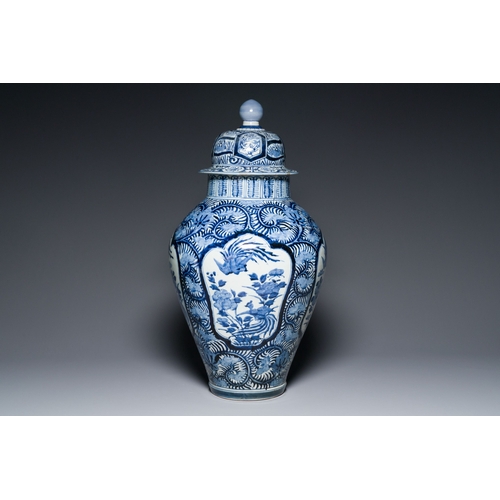 532 - A pair of Japanese Imari vases with flower-topped covers and a large blue and white Arita vase, Edo,... 