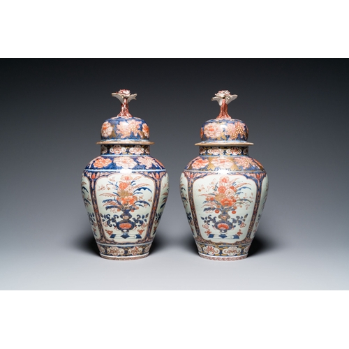 532 - A pair of Japanese Imari vases with flower-topped covers and a large blue and white Arita vase, Edo,... 