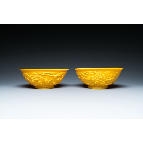 578 - A pair of Chinese yellow Beijing glass bowls with figures in mountainous landscapes, 19/20th C.Descr... 