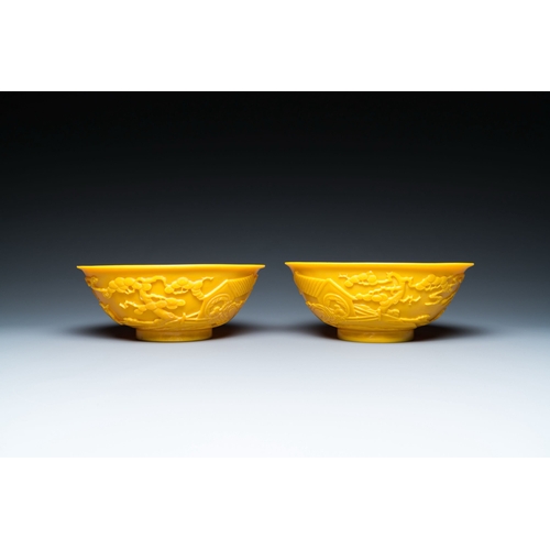 578 - A pair of Chinese yellow Beijing glass bowls with figures in mountainous landscapes, 19/20th C.Descr... 