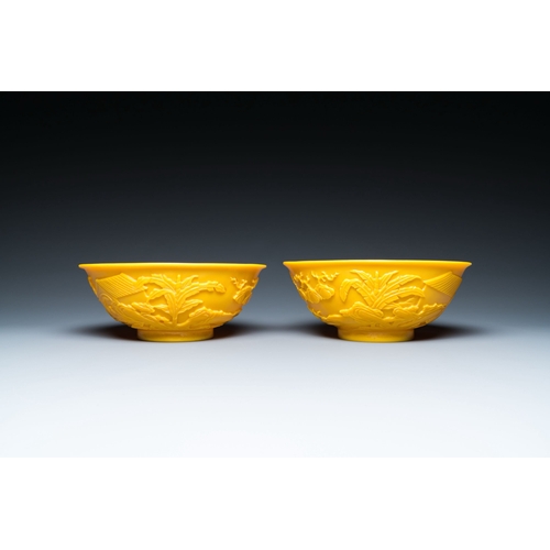 578 - A pair of Chinese yellow Beijing glass bowls with figures in mountainous landscapes, 19/20th C.Descr... 