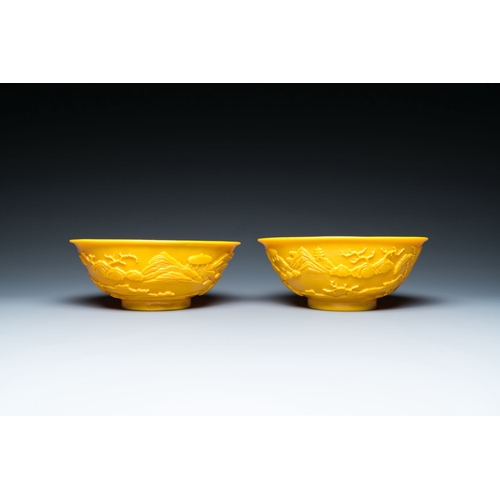 578 - A pair of Chinese yellow Beijing glass bowls with figures in mountainous landscapes, 19/20th C.Descr... 