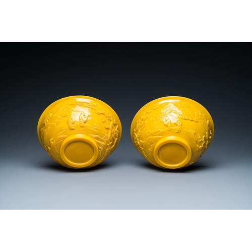 578 - A pair of Chinese yellow Beijing glass bowls with figures in mountainous landscapes, 19/20th C.Descr... 