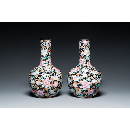 581 - A pair of Chinese famille rose black-ground millefleurs bottle vases, Qianlong mark, RepublicDescrip... 