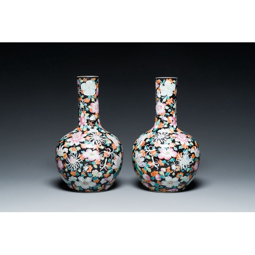 581 - A pair of Chinese famille rose black-ground millefleurs bottle vases, Qianlong mark, RepublicDescrip... 