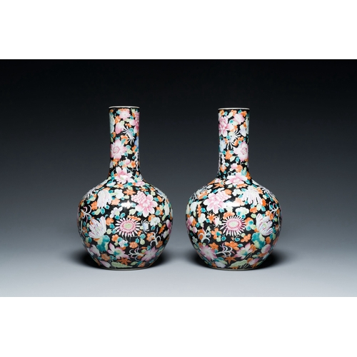 581 - A pair of Chinese famille rose black-ground millefleurs bottle vases, Qianlong mark, RepublicDescrip... 