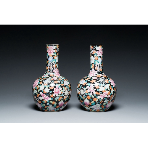 581 - A pair of Chinese famille rose black-ground millefleurs bottle vases, Qianlong mark, RepublicDescrip... 