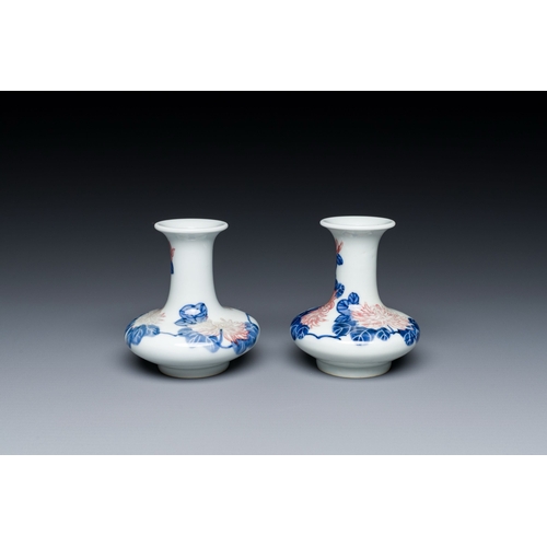 589 - A pair of Chinese blue, white and copper-red vases with floral design, Qianlong mark, 19/20th C.Desc... 