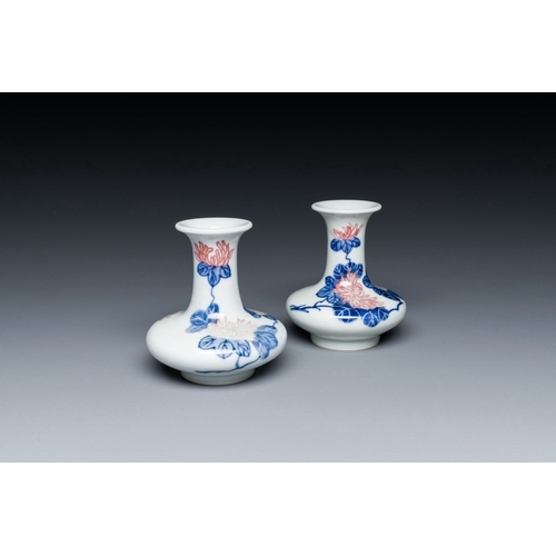 589 - A pair of Chinese blue, white and copper-red vases with floral design, Qianlong mark, 19/20th C.Desc... 