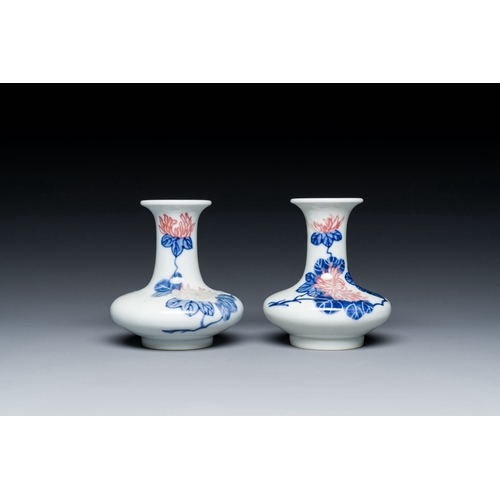 589 - A pair of Chinese blue, white and copper-red vases with floral design, Qianlong mark, 19/20th C.Desc... 