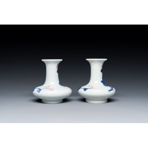 589 - A pair of Chinese blue, white and copper-red vases with floral design, Qianlong mark, 19/20th C.Desc... 