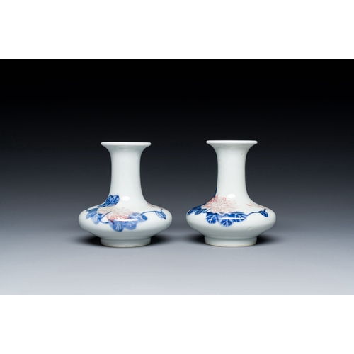 589 - A pair of Chinese blue, white and copper-red vases with floral design, Qianlong mark, 19/20th C.Desc... 