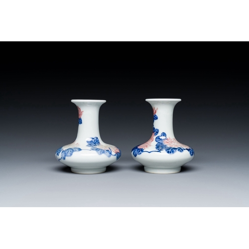 589 - A pair of Chinese blue, white and copper-red vases with floral design, Qianlong mark, 19/20th C.Desc... 