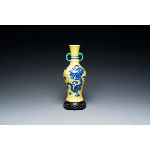 594 - A Chinese blue and white yellow-ground 'dragon' vase with green-glazed handles on a jade-inset woode... 