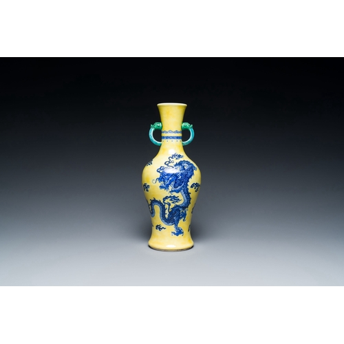 594 - A Chinese blue and white yellow-ground 'dragon' vase with green-glazed handles on a jade-inset woode... 