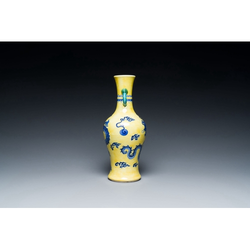 594 - A Chinese blue and white yellow-ground 'dragon' vase with green-glazed handles on a jade-inset woode... 