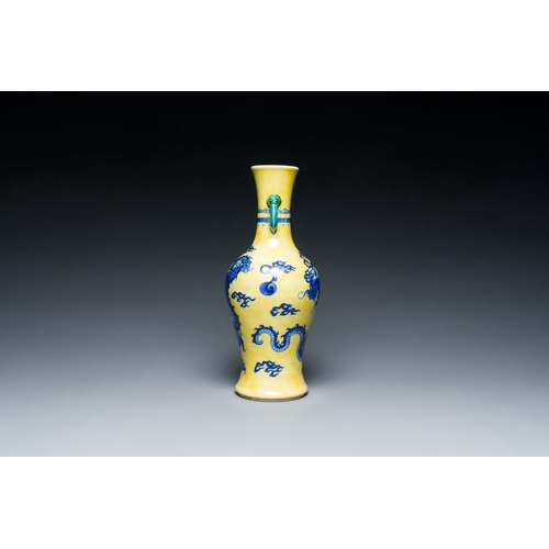 594 - A Chinese blue and white yellow-ground 'dragon' vase with green-glazed handles on a jade-inset woode... 