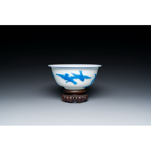 595 - A fine Chinese overlay Beijing glass bowl with birds and flowers in blue on white, 19/20th C.Descrip... 