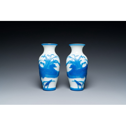 644 - A pair of Chinese overlay Beijing glass vases with mandarin ducks in blue on white, 19/20th C.Descri... 