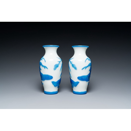 644 - A pair of Chinese overlay Beijing glass vases with mandarin ducks in blue on white, 19/20th C.Descri... 