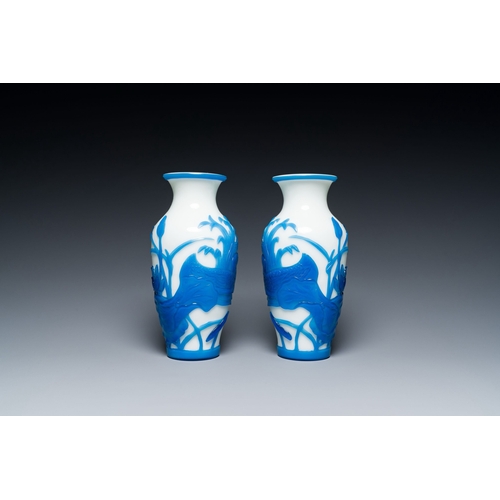 644 - A pair of Chinese overlay Beijing glass vases with mandarin ducks in blue on white, 19/20th C.Descri... 