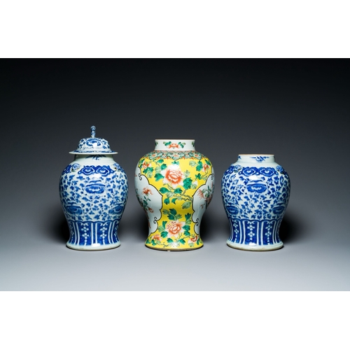 702 - Three Chinese blue, white and famille verte vases, 19th C.Description:H.: 40 cm (the vase with the c... 