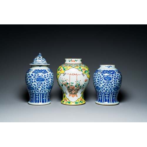 702 - Three Chinese blue, white and famille verte vases, 19th C.Description:H.: 40 cm (the vase with the c... 