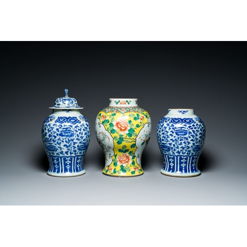 702 - Three Chinese blue, white and famille verte vases, 19th C.Description:H.: 40 cm (the vase with the c... 