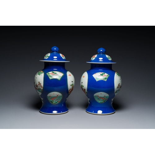 723 - A pair of Chinese powder-blue-ground famille verte vases and covers, 19th C.Description:H.: 40,5 cmC... 