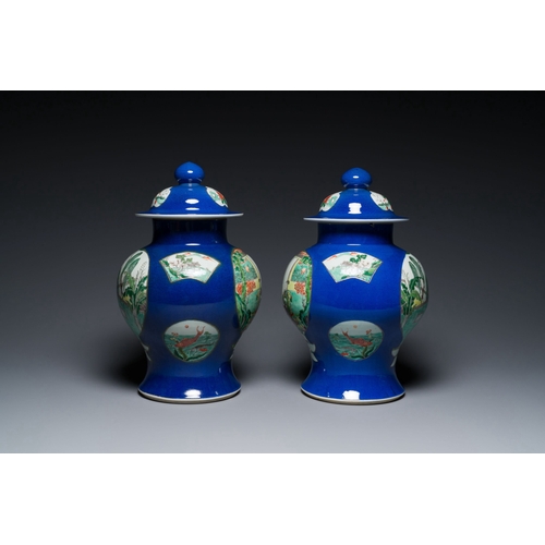 723 - A pair of Chinese powder-blue-ground famille verte vases and covers, 19th C.Description:H.: 40,5 cmC... 