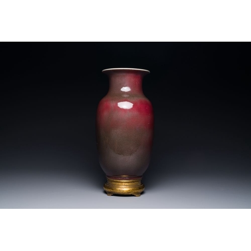 148 - A Chinese monochrome copper-red-glazed vase with gilt bronze mount, 18/19th CH.: 37,5 cm (incl. stan... 