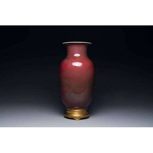 148 - A Chinese monochrome copper-red-glazed vase with gilt bronze mount, 18/19th CH.: 37,5 cm (incl. stan... 