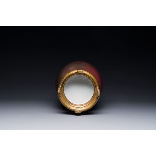 148 - A Chinese monochrome copper-red-glazed vase with gilt bronze mount, 18/19th CH.: 37,5 cm (incl. stan... 