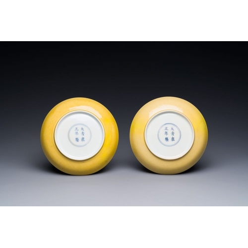 166 - A pair of Chinese monochrome yellow-glazed saucers with incised designs of pine and cranes, Yongzhen... 