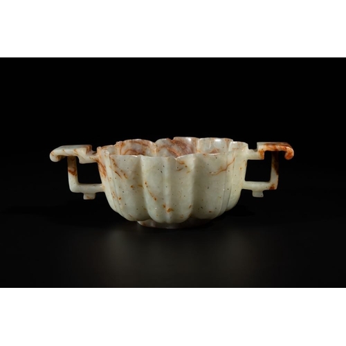 100 - A Chinese celadon and russet jade wedding cup, 18th C.L.: 19 cm - H.: 5,9 cm Weight: 316 gramsThe ab... 