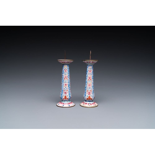 162 - A pair of Chinese Canton enamel candlesticks with floral design, Yongzheng/QianlongH.: 13 cmThe abse... 