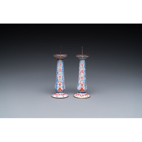 162 - A pair of Chinese Canton enamel candlesticks with floral design, Yongzheng/QianlongH.: 13 cmThe abse... 