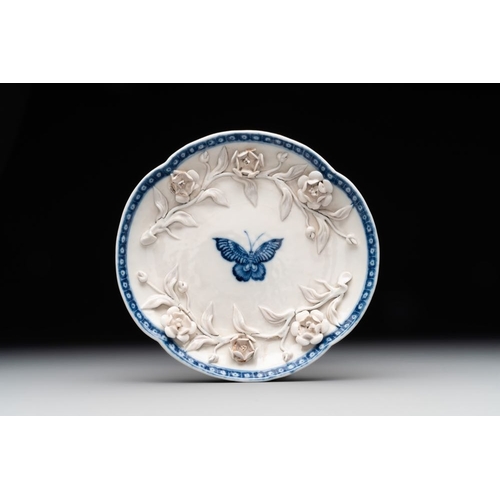 253 - A Chinese blue and white 'butterfly' cup and saucer with applied floral design, QianlongL.: 7,8 cm -... 