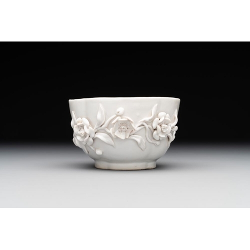 253 - A Chinese blue and white 'butterfly' cup and saucer with applied floral design, QianlongL.: 7,8 cm -... 