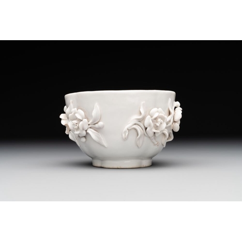 253 - A Chinese blue and white 'butterfly' cup and saucer with applied floral design, QianlongL.: 7,8 cm -... 