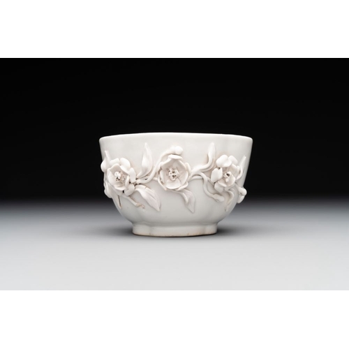 253 - A Chinese blue and white 'butterfly' cup and saucer with applied floral design, QianlongL.: 7,8 cm -... 